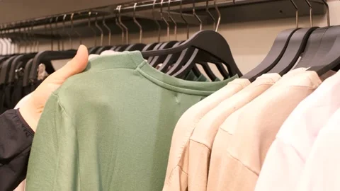 A man chooses clothes in a retail mall close-up, shopping concept. Stock Footage 175836742