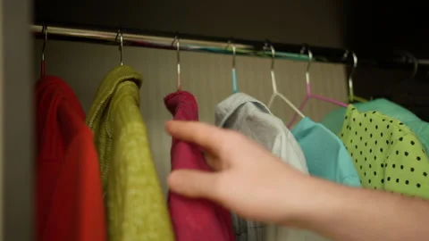 A man chooses clothes in a wall cupboard, close-up Stock Footage 131365907
