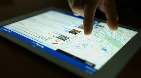 Man chooses hotel through the application Booking on a Tablet PC Stock Footage 47761720