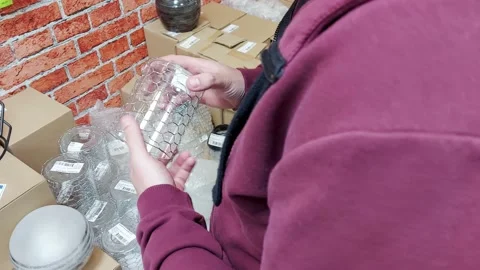 A man chooses a lighting lamp in the electrical department of a hardware store Stock Footage 157878761