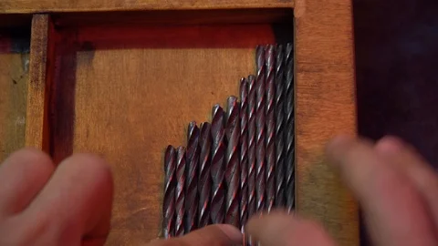 The man chooses the necessary drill among many others Stock Footage 126749264