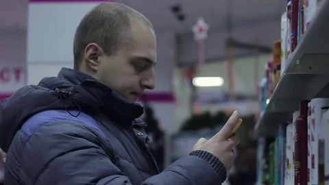 Man chooses shampoo in store Stock Footage 71007770