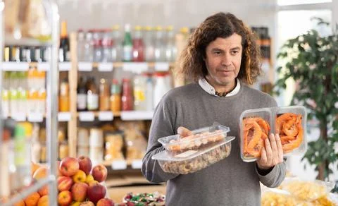 Man chooses shrimp and shellfish Stock Photos