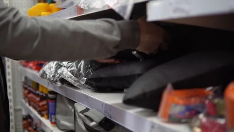 A man chooses a small pillow in the store. Stock Footage 90482484