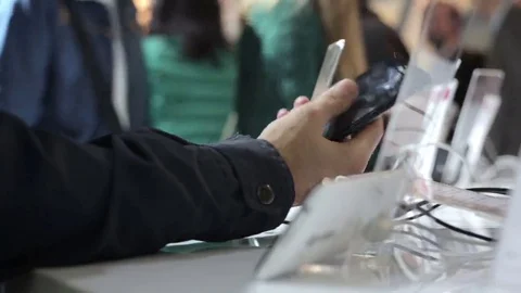 Man Chooses a Smartphone in a Store Stock Footage 69126032
