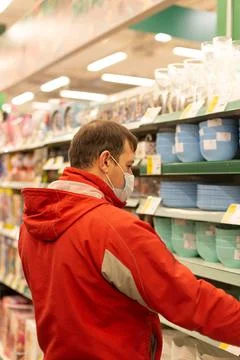 A man chooses tableware in the shop Stock Photos