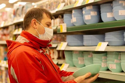 A man chooses tableware in the shop Stock Photos