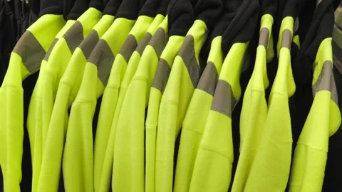 A man chooses work clothes with reflective elements.for general workers hang Stock Footage 297816690