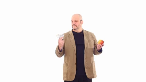 Man choosing between pills and natural food white screen Stock Footage 104980239