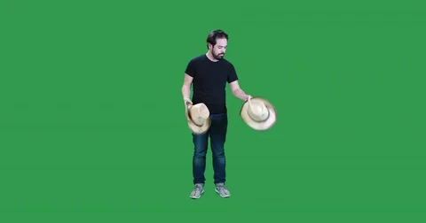 Man choosing between two cowboy hats gets swarmed by bees Stock-Footage 83629990