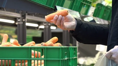 A man choosing carrots at store 動画素材 74136323