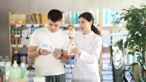 Man choosing cream with help from pharmacist Stock Footage 341531870