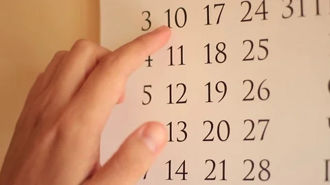 Man is Choosing Date by the Hand at the Calender Stock-Footage 70505220
