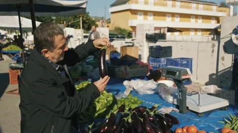 Man choosing Eggplant Stock Footage 168821112