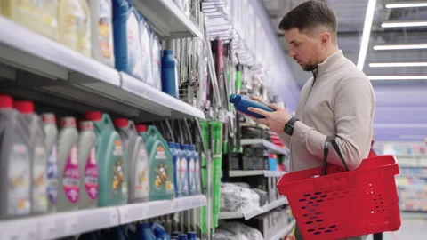Man choosing engine oil in auto parts shop Stock Footage 156049357
