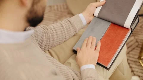 Man choosing fabric textile samples for interior design Stock Footage 322550149