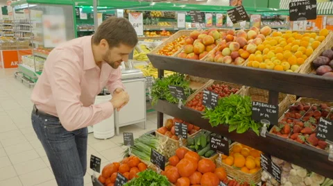 Man choosing lemons at the supermarket Stock Footage 63371498