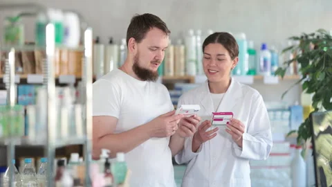 Man choosing paracetamol with help from pharmacist Stock Footage 315549946