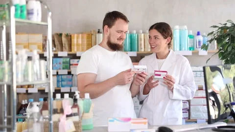 Man choosing paracetamol with help from pharmacist Stock Footage 323907104
