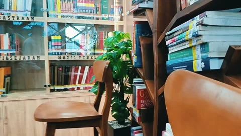 Man choosing picking up right book from bookshelf in office library Stock Footage 289921979