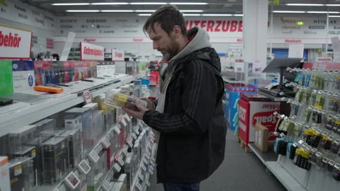 Man Choosing SSD Drive Inside Branded Electronics Retail Store Aisle Stock Footage 336474548