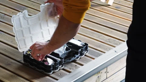 A man choosing a thing in box with multiple different screws and instruments Stock Footage 145170146