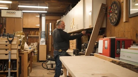 Man choosing tool for project in woodworking workshop Stock Footage 102045185