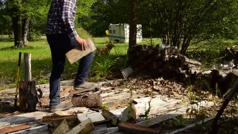 Man chopping and stacking wood on country farm   Wide shot 스톡 동영상 79407252