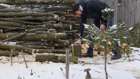 Man Chopping Down Wood In Winter Stock Footage 87698504