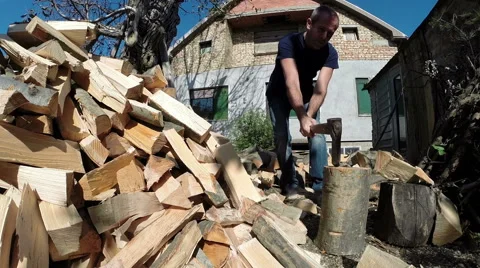 Man Chopping Firewood With an Axe Stock Footage 42758313