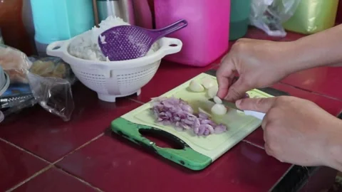 A man is chopping garlic Stock Footage 242570071
