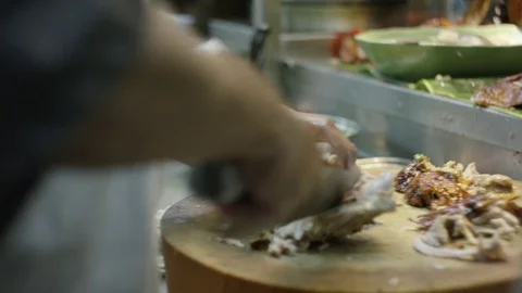 Man chopping grilled meat Stock Footage 73243525
