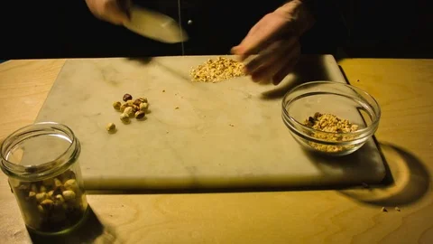 Man chopping hazelnut nuts. 動画素材 79866374