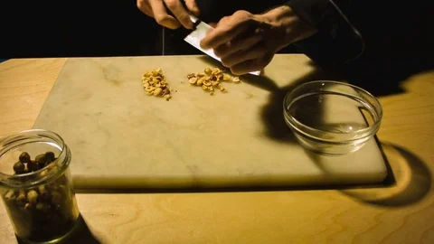 Man chopping hazelnut nuts. 動画素材 79867931