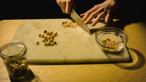 Man chopping hazelnut nuts. Stock Footage 79868915