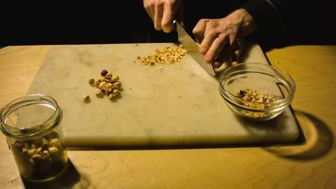 Man chopping hazelnut nuts. 스톡 동영상 79874584