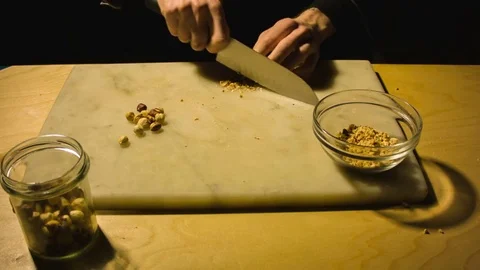 Man chopping hazelnut nuts. Stock Footage 79904287