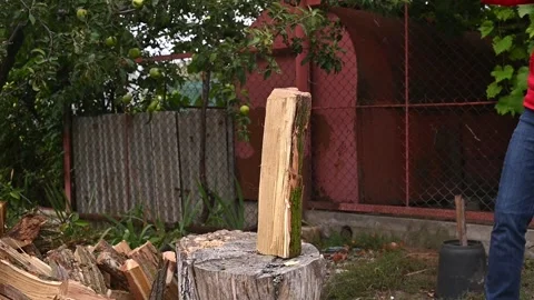 Man chopping log with axe in backyard. Stock Footage 331906057