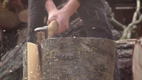 Man chopping log with an axe slow motion Stock Footage 99704459