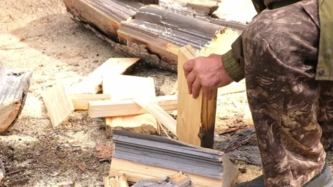 A man is chopping logs with an axe on chopping block. Harvesting of firewood Stock Footage 219751526