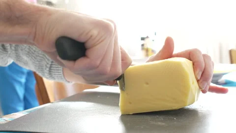 Man chopping raclette cheese Stock Footage 232945418