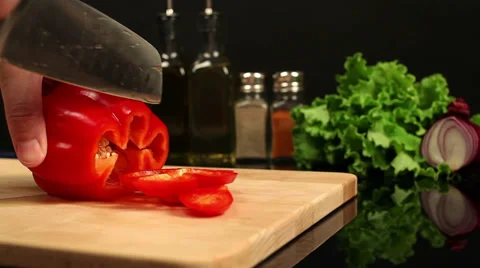 Man chopping red bell pepper on a cutting board Stock Footage 39948492