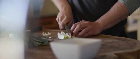 Man chopping vegetable on chopping board in the Kitchen Stock Footage 69200319