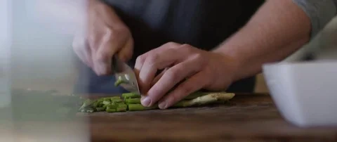 Man chopping vegetable on chopping board in the Kitchen Stock Footage 69200347