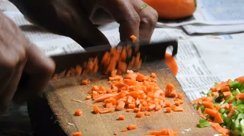 Man chopping vegetables in kitchen counter in a Indian kitchen 動画素材 64809175