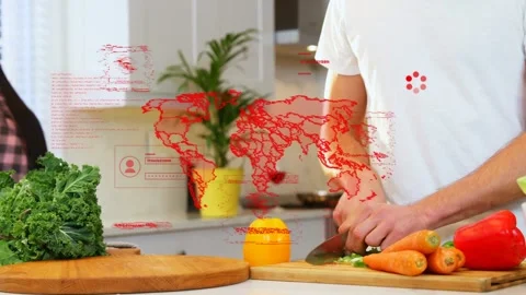 Man chopping veggies at kitchen island, hack warnings causing red map overlay Stock Footage 333078564