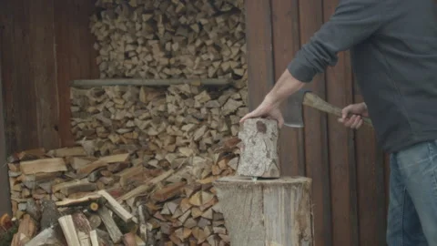 Man Chopping Woods With An Axe. Pile Of Firewood. Chopped And Stacked Wood Stock Footage 265086741