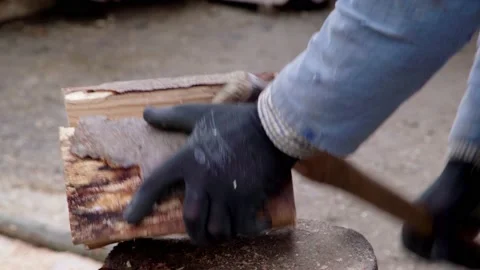 A man chops firewood with an ax in the yard. Stock Footage 149918257