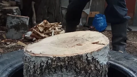 Man chops firewood on backyard. Video stock 130258486