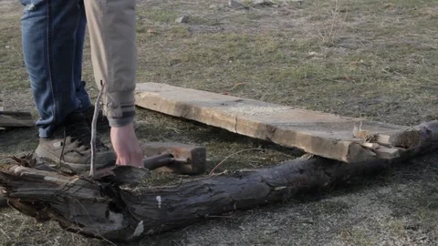 Man chops firewood using sledgehammers Stock Footage 74665186